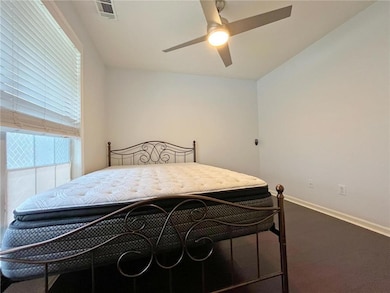 Bedroom featuring baseboards, visible vents, and a ceiling fan