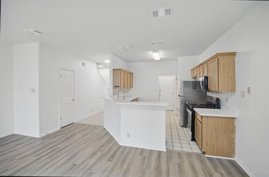 Kitchen with black range with gas stovetop, stain