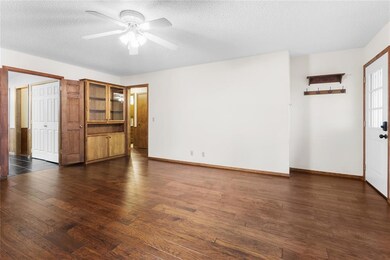 Unfurnished living room with a textured ceiling, c