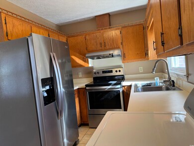 Kitchen with a textured ceiling, stainless steel a