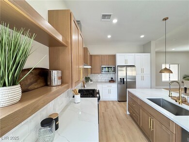 Kitchen featuring tasteful backsplash, visible ven