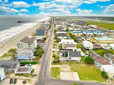 Bird's eye view with a view of the beach and a wat