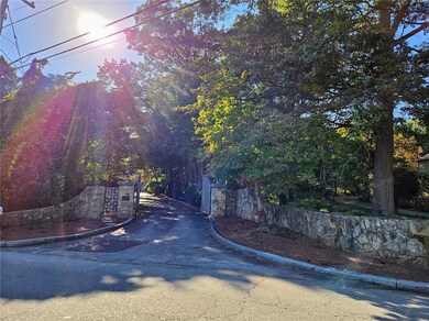 Stone Wall at entry with wrought iron gate