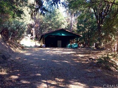 Street view of covered carport with concrete. Plen