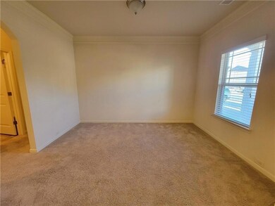 Spare room with light carpet, baseboards, arched w