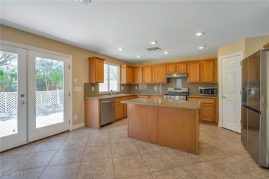 Kitchen featuring visible vents, a sink, stainless