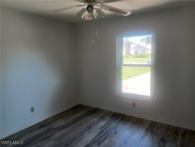 Spare room with dark wood finished floors, ceiling