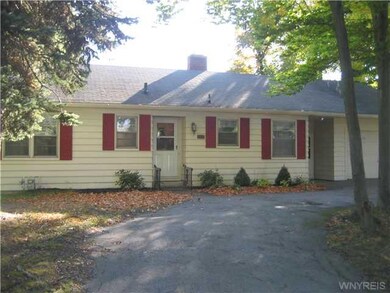 Exterior Front Mature tress line the horseshoe dri