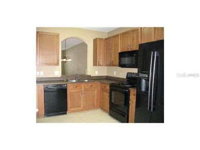 The kitchen has a sliding glass out to the screene