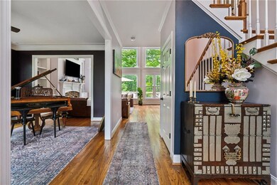 Entrance foyer featuring stairs, ornamental moldin