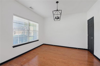 Bedroom featuring light wood-style floors and a chandelier