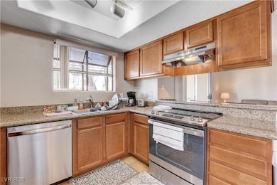 Kitchen featuring stainless steel appliances, unde