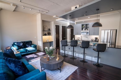 Living room featuring sink, hardwood / wood-style 