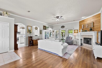 Large living room with laminate floors, wood burni