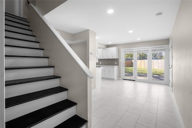 Staircase featuring recessed lighting and baseboards