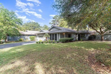 Ranch-style house featuring a garage and a front y
