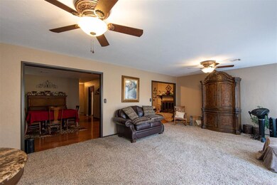 Living room with a fireplace, wood-type flooring, 