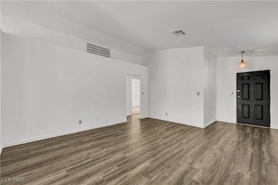 Spare room featuring wood finished floors