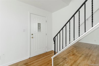 Entryway with stairway and light wood-style floors