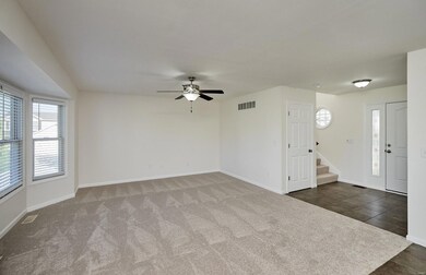Family room features a large bay window, New carpe