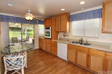 Kitchen and nook open to the back patio and greenb