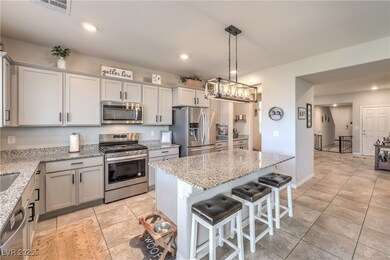 Kitchen with a kitchen bar, a kitchen island, ligh
