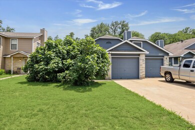 View of front of property featuring a garage, a f