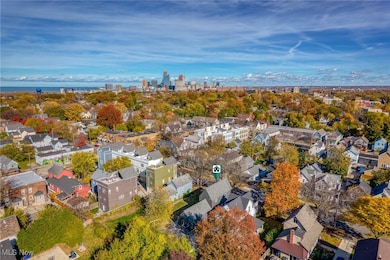 View of property location featuring a tree filled landscape and nearby urban area