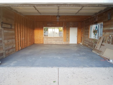 Garage featuring wood walls and a garage door opener
