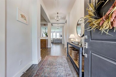 Foyer with a chandelier and dark hardwood / wood-s