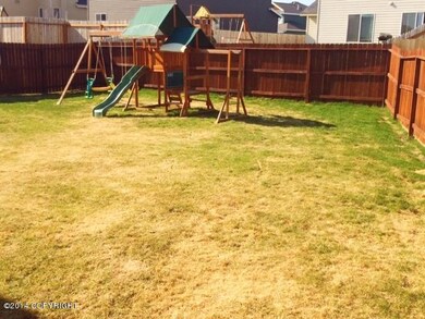 Fenced back yard-play set stays!