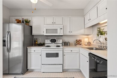 Kitchen with, white cabinetry, light floors, and a sink