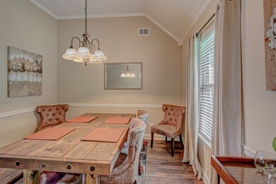 Leading from the Great Room, this gorgeous Dining room has Wood Laminate floors, neutral decor and High Ceilings with plenty of Light