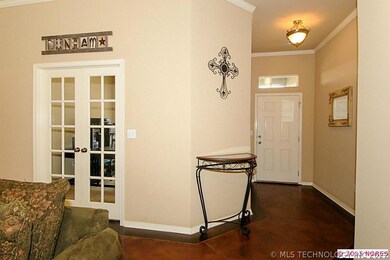 View towards front entry and office French doors.