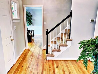 The Welcoming Foyer offers Gleaming Hardwood Flooring, Front Storm Door, Multi-Member Crown Molding, Tasteful Light Fixture, and a Convenient Coat Closet! Foyer also has the Stairs to the 2nd Floor and Large Entry to the Living Room!