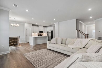 Living room featuring wood-type flooring, a chande