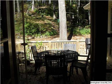 FRENCH DOORS IN THE DINING ROOM OPEN TO THE UNBELI