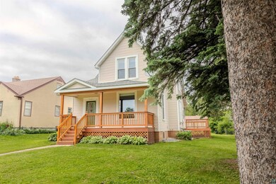 View of front of home featuring covered porch and a front yard