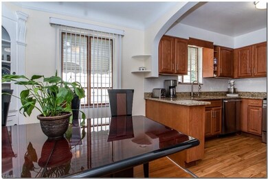 Dining Room with Corner Curio Cabinets and Hardwoo