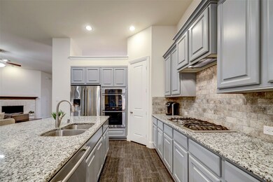 Side view of kitchen showing abundance of countertop space and cabinets.
