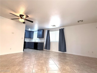 Kitchen featuring light countertops, ceiling fan,