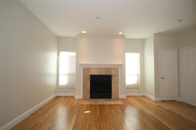Living area has wood-burning fireplace and shades 