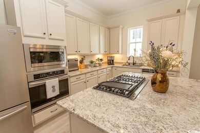 Kitchen with light stone countertops, light wood f