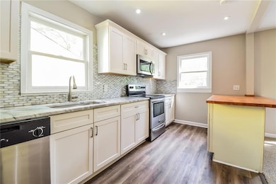 Kitchen featuring backsplash, wooden counters, whi