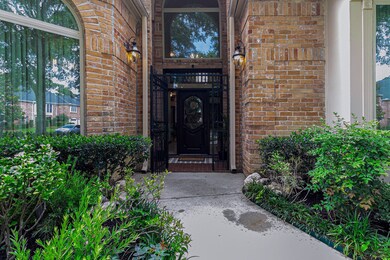 Welcoming brick entrance with decorative wrought i