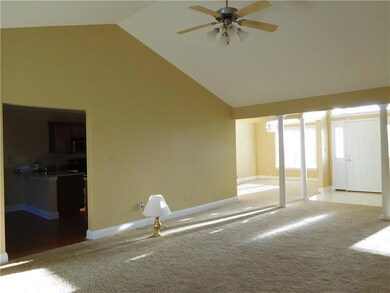 Open living area with vaulted ceilings and bright 