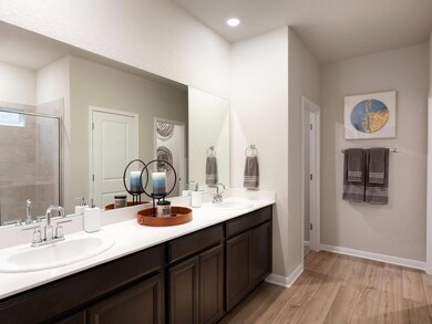 Full bathroom featuring double vanity, wood finis