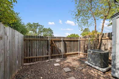 Fenced backyard featuring a gate