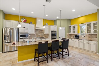 This kitchen is by far any chef’s dream! This spacious kitchen features high ceilings, white stained wood cabinets, granite countertops, SS appliances, modern tile backsplash, recessed lighting with additional custom pendant lighting, extended counter space, granite kitchen island, space for breakfast bar and a walk-in pantry all overlooking your huge family room.
