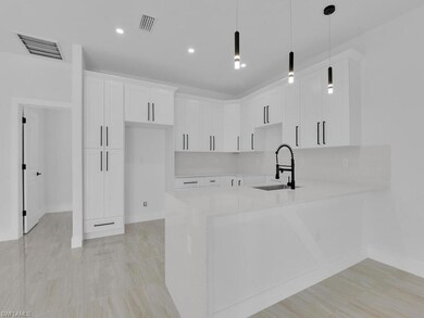 Kitchen with sink, kitchen peninsula, white cabine